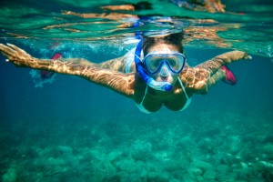 Young women at snorkeling in the tropical water at andaman