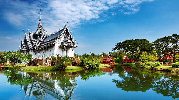 A white building by a lake in Bangkok